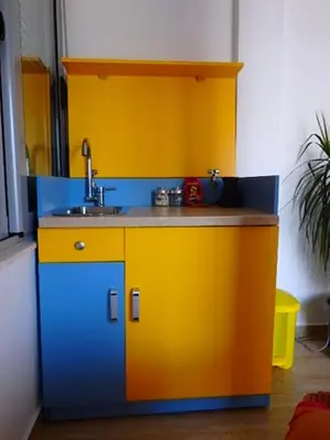 a colorful kitchen with a sink in a room at Apartmani Hamburg 1 in Donji Štoj
