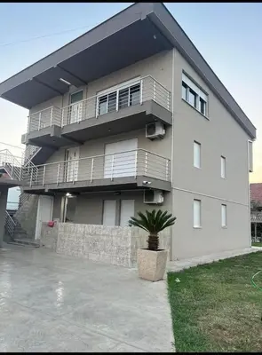 a large building with a potted plant in front of it at huzur ve güven in Podgorica