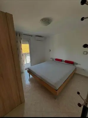 a bedroom with a bed in a room with a door at huzur ve güven in Podgorica