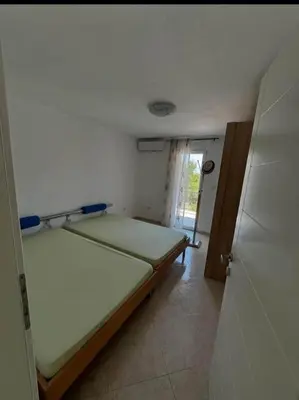 a bedroom with two beds in a room with a door at huzur ve güven in Podgorica