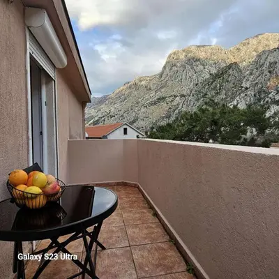 a bowl of fruit on a table on a balcony at Studio Ines in Kotor