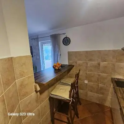 a kitchen with a table and chairs in a room at Studio Ines in Kotor