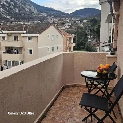 a table on a balcony with a bowl of fruit on it at Studio Ines in Kotor