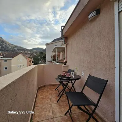 a small balcony with a table and chairs on a building at Studio Ines in Kotor