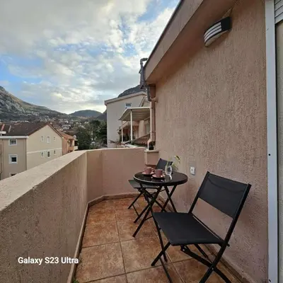 a small balcony with a table and chair on a building at Studio Ines in Kotor