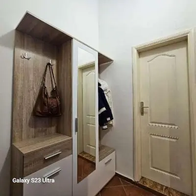 a walk in closet with a mirror and a door at Studio Ines in Kotor