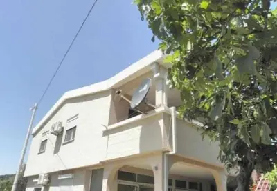 a white building with a window on the side of it at Apartments Masa in Sutomore