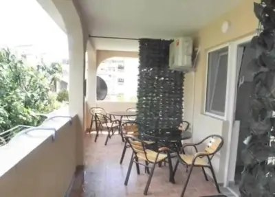 a group of chairs and tables on a patio at Apartments Masa in Sutomore