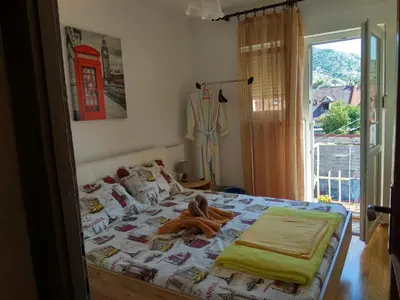 a bedroom with a bed with a teddy bear on it at Apartment Tea in Cetinje