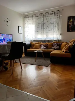 a living room with a couch and a table at Apartment Tea in Cetinje