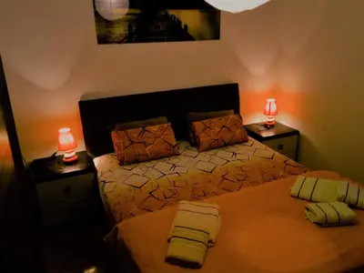 a bedroom with a bed and two lamps on tables at Apartment Tea in Cetinje