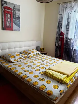 a bed in a bedroom with a red telephone booth at Apartment Tea in Cetinje