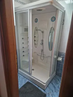 a shower in a bathroom with two mirrors at Riverview in Podgorica
