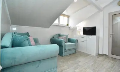 a living room with a couch and a tv at One bedroom apartment Old town in Budva