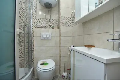 a bathroom with a toilet and a sink and a shower at One bedroom apartment Old town in Budva