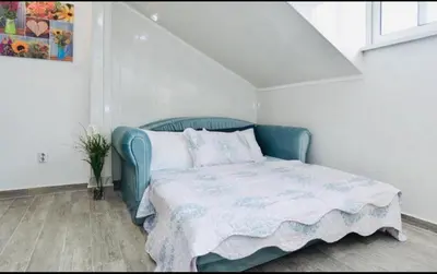 a small bedroom with a blue bed with a blanket at One bedroom apartment Old town in Budva