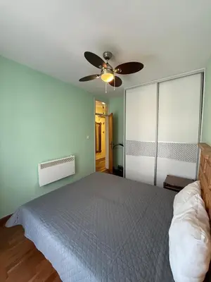 a bedroom with a bed and a ceiling fan at Coasthouse Budva in Budva