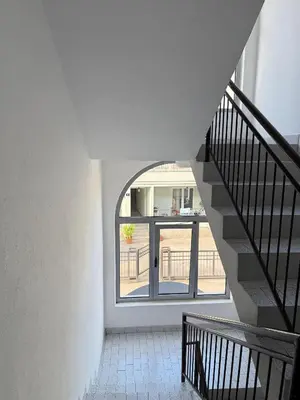 a stairway with a window and a stair case at Coasthouse Budva in Budva