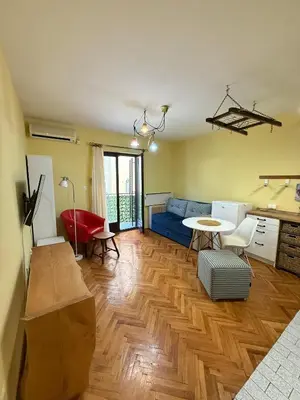 a living room with a blue couch and a table at Coasthouse Budva in Budva