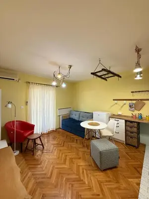 a living room with a blue couch and a table at Coasthouse Budva in Budva