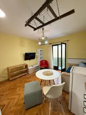 a living room with a table and a couch at Coasthouse Budva in Budva