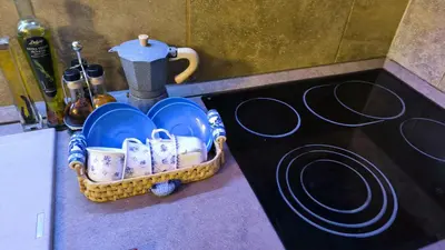 a basket of dishes sitting on a counter next to a stove at Apartament - Lisa in Budva