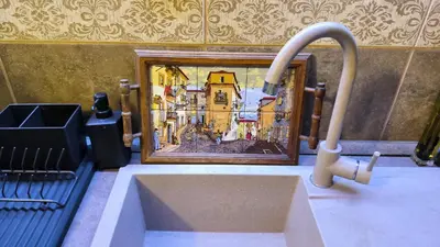 a sink with a picture of a city in a frame at Apartament - Lisa in Budva