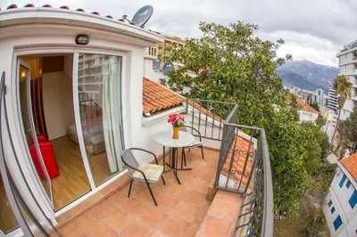 a balcony with a table and chairs on a balcony at Apartments Luka in Budva