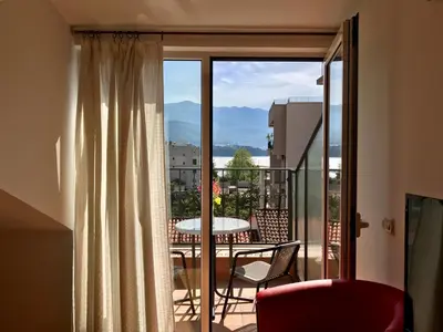 a room with a balcony with a table and chairs at Apartments Luka in Budva