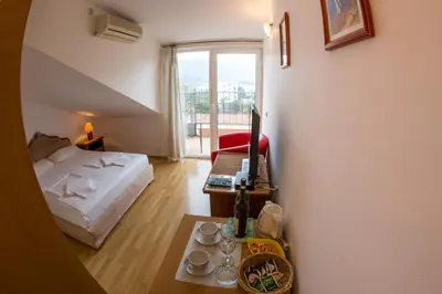 a small room with a bed and a table with a coffee table at Apartments Luka in Budva