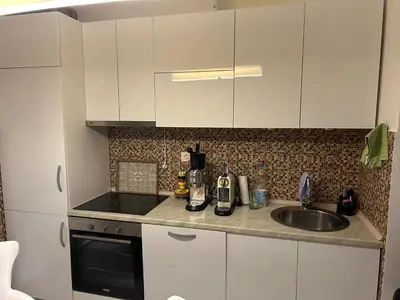 a kitchen with white cabinets and a sink at Apart Bella Utjeha Sea View 68 qm in Utjeha