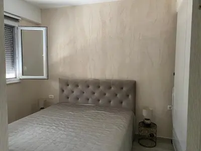 a bedroom with a bed with a large headboard and a window at Apart Bella Utjeha Sea View 68 qm in Utjeha