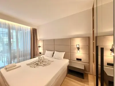 a bedroom with a large white bed and a window at Air Onia in Budva