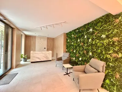 an office with a green wall with chairs and a desk at Air Onia in Budva