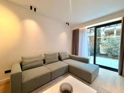 a living room with a couch and a large window at Air Onia in Budva