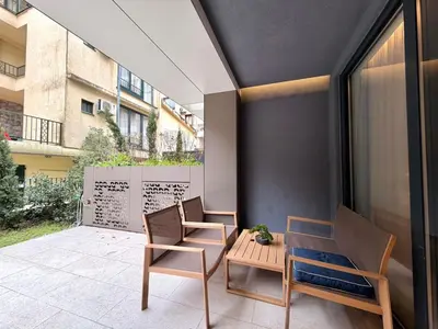 a patio with two chairs and a table on a balcony at Air Onia in Budva