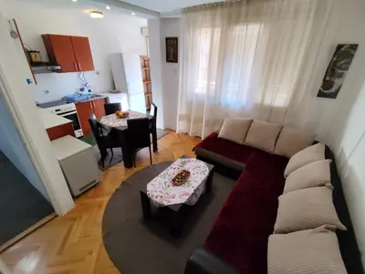 a living room with a couch and a table at HarmonyHome in Podgorica