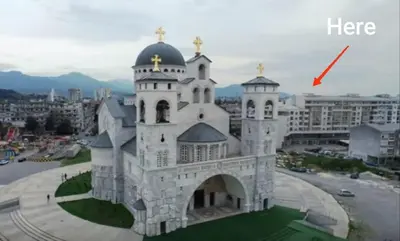 a large white building with a cross on top at HarmonyHome in Podgorica