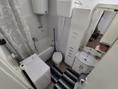 a small bathroom with a toilet and a sink at HarmonyHome in Podgorica