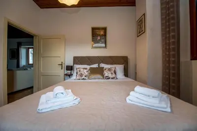 a bedroom with a bed with towels on it at Mediteraneo Villa in Kaluđerovići