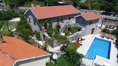 an aerial view of a house with a swimming pool at Mediteraneo Villa in Kaluđerovići