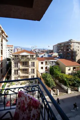 a balcony with a chair and a view of a city at Central Budva M Lux Apartments in Budva