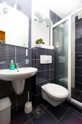 a bathroom with a toilet and a sink and a shower at Central Budva M Lux Apartments in Budva
