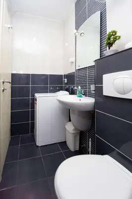 a bathroom with a sink and a toilet and a mirror at Central Budva M Lux Apartments in Budva