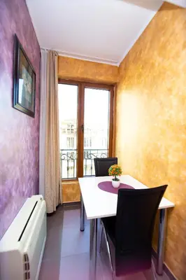 a dining room with a table and chairs and a window at Central Budva M Lux Apartments in Budva