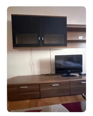 a tv on top of a wooden entertainment center at Sshome in Podgorica