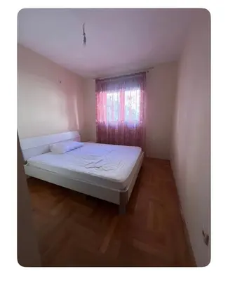 a small bedroom with a bed and a window at Sshome in Podgorica