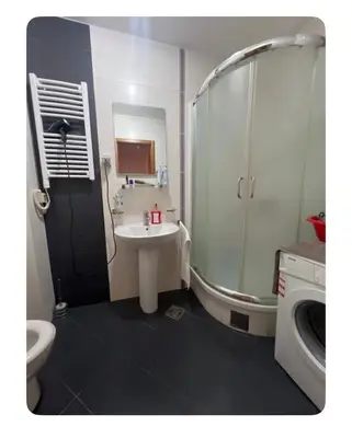 a small bathroom with a sink and a shower at Sshome in Podgorica