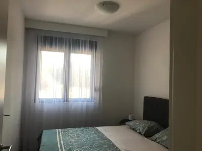 a bedroom with a bed and a window at Green Harmony in Kotor