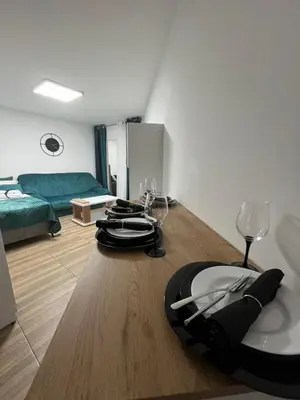 a room with a table with wine glasses on it at Budva apartman Vasić in Budva